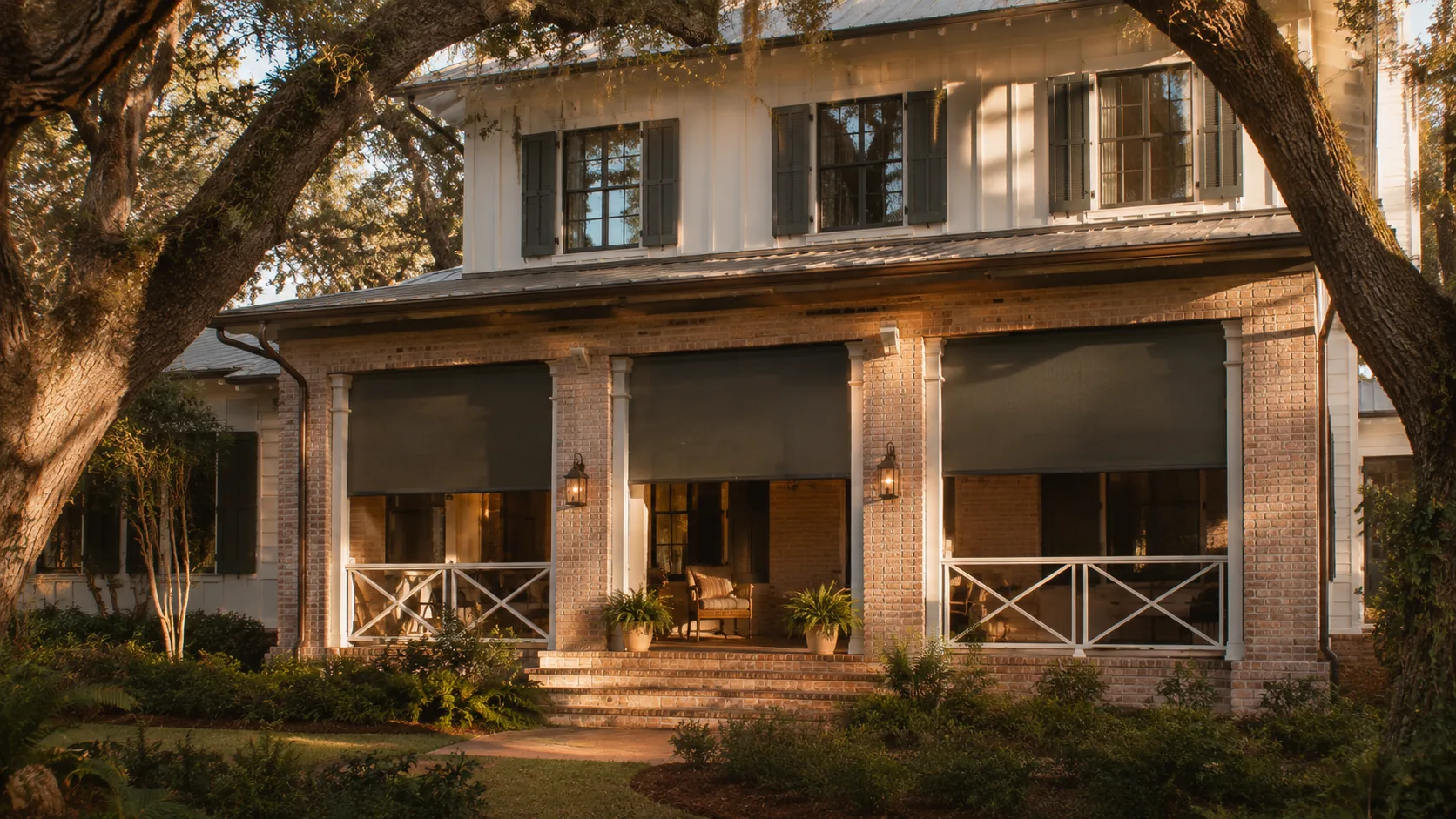 Two-story Southern home with deep sun-blocking exterior roller shades on three covered openings